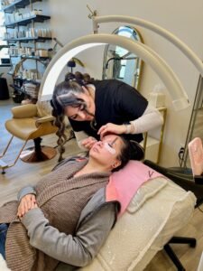 Esthetician applying classic eyelash extensions and lash tint using precision technique – LashLuv Beauty Bar in Bothell WA, serving Kenmore, Mill Creek, and Woodinville