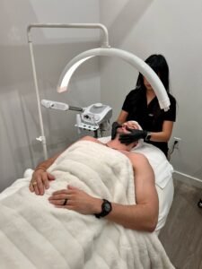 esthetician performing a facial at lashluv beauty bar in bothell wa