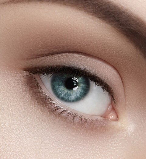 Close-up of a woman with classic lash extensions in a studio setting at a Bothell, WA lash salon.