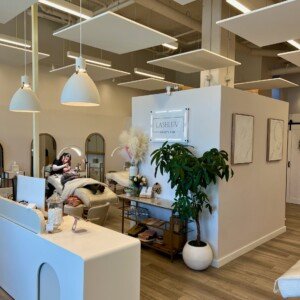 View of LashLuv Beauty Bar in Bothell WA showing the reception area, treatment beds, and esthetician performing a service β serving Mill Creek, Kenmore, and Woodinville clients
