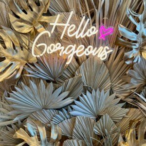 βHello Gorgeousβ neon sign with gold leaf decor at LashLuv Beauty Bar in Bothell WA β a stylish selfie spot for clients from Mill Creek, Kenmore, and Woodinville