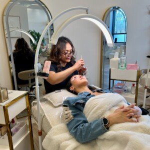 Lash artist applying hybrid eyelash extensions for a soft, full finish β expert lash services at LashLuv Beauty Bar in Bothell WA